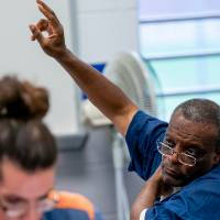 Student raising hand to ask question during class